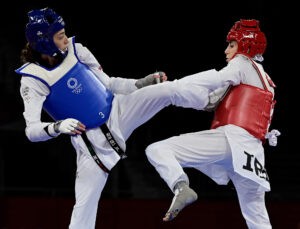 Refugee Olympic Team's Kimia Alizadeh Zenoorin (Blue) and Iran's Nahid Kiyanichandeh (Red)
